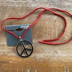 Never used enamel Peace Sign Necklace on a red cord.